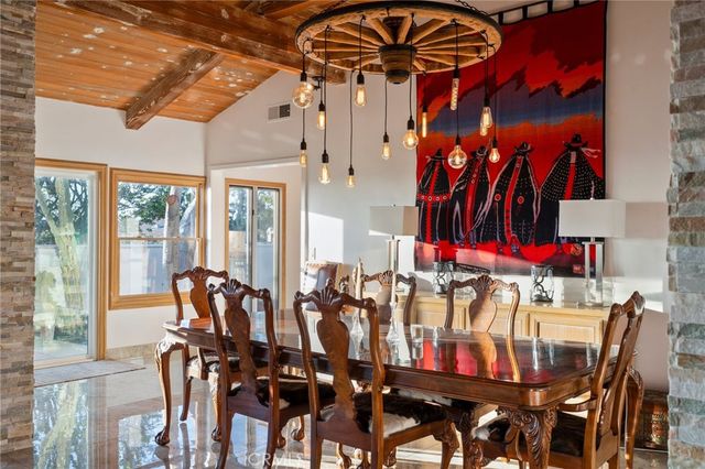 a large kitchen that has a lot of cabinets table and chairs