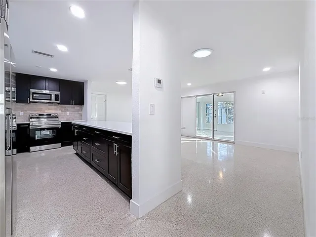 a kitchen with stainless steel appliances a sink stove and microwave