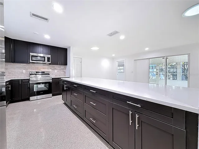 a kitchen with a stove and a microwave