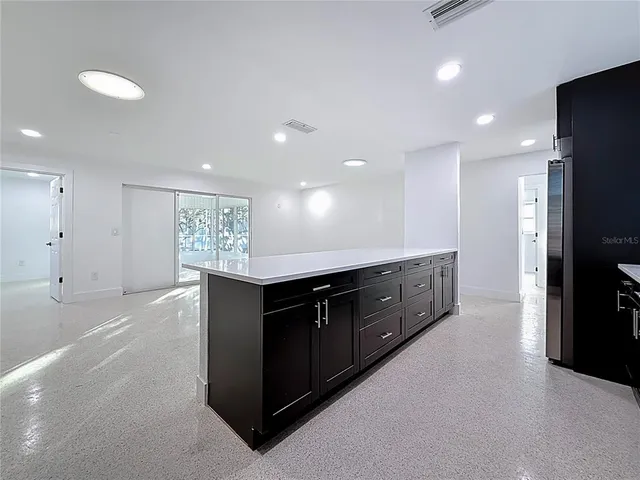 a kitchen with a sink and white cabinets