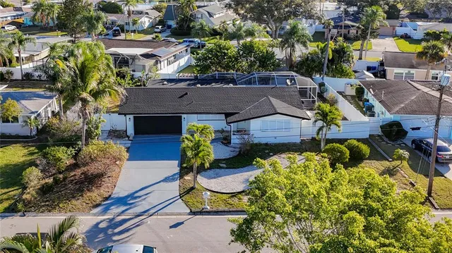 an aerial view of a house with garden space and street view