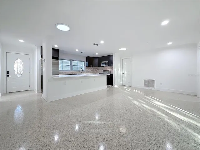 an empty room with a empty space and windows