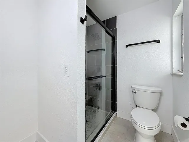 a view of empty room with floor to ceiling window and stairs