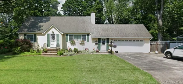 a view of house and yard with green space