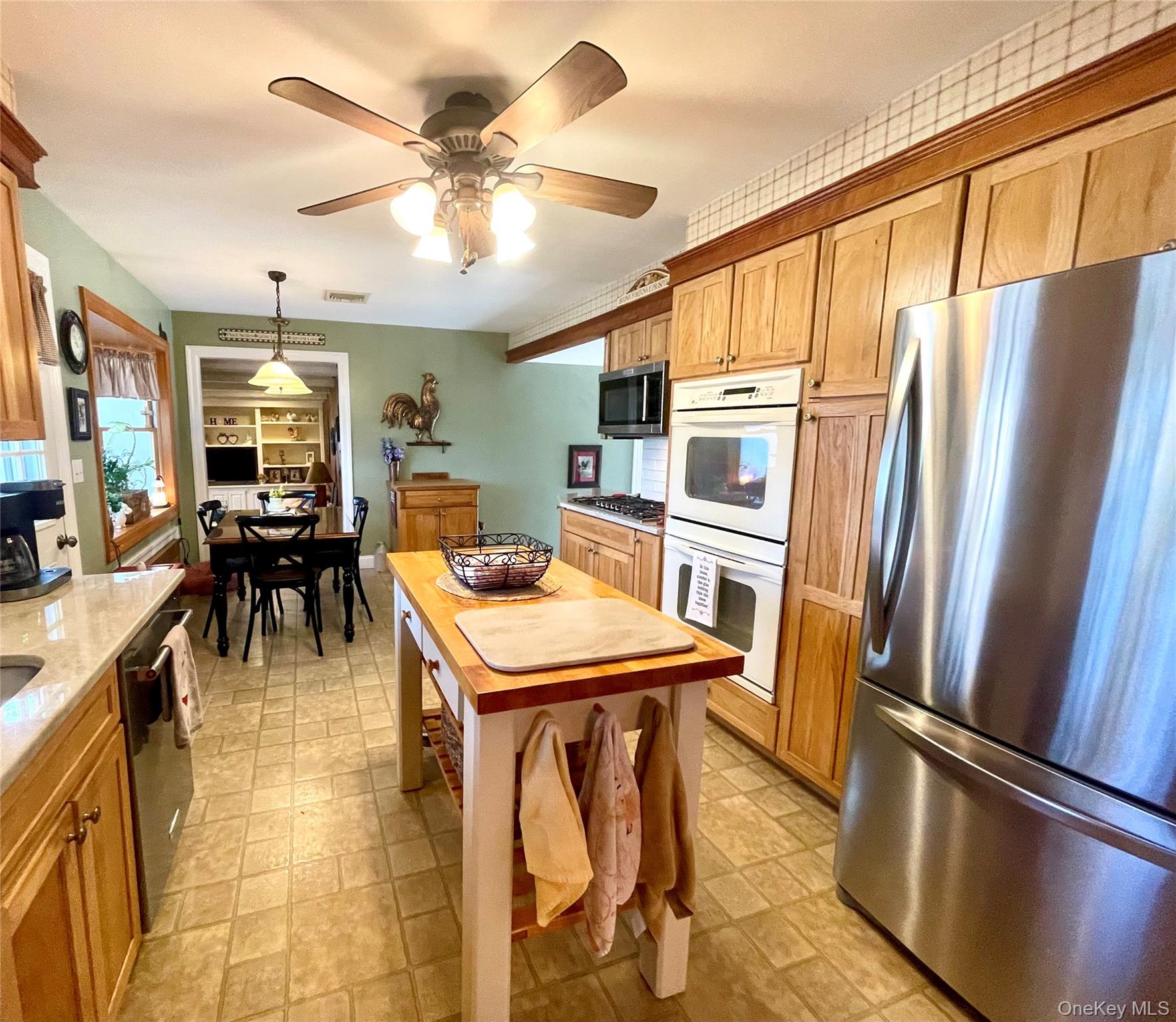 4 Sylvan Way Suffern, NY 10901 - Photo 11 of 39 a kitchen with stainless steel appliances granite countertop a refrigerator a stove a sink dishwasher and a dining table with wooden floor