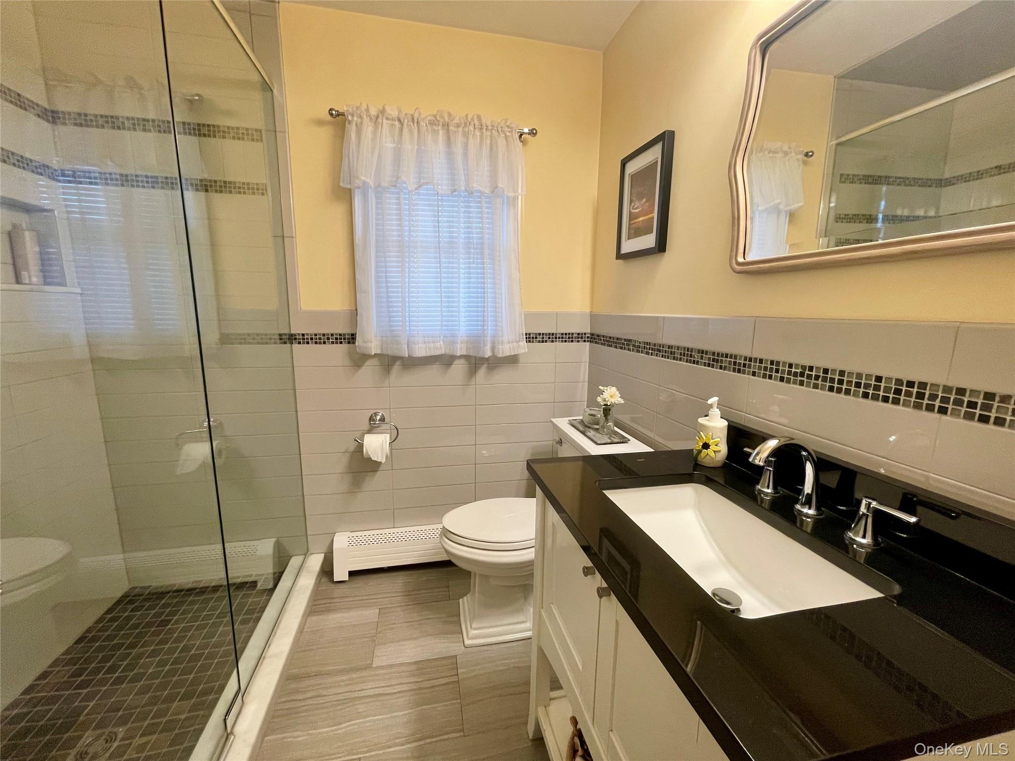 4 Sylvan Way Suffern, NY 10901 - Photo 16 of 39 a bathroom with a sink a toilet and shower
