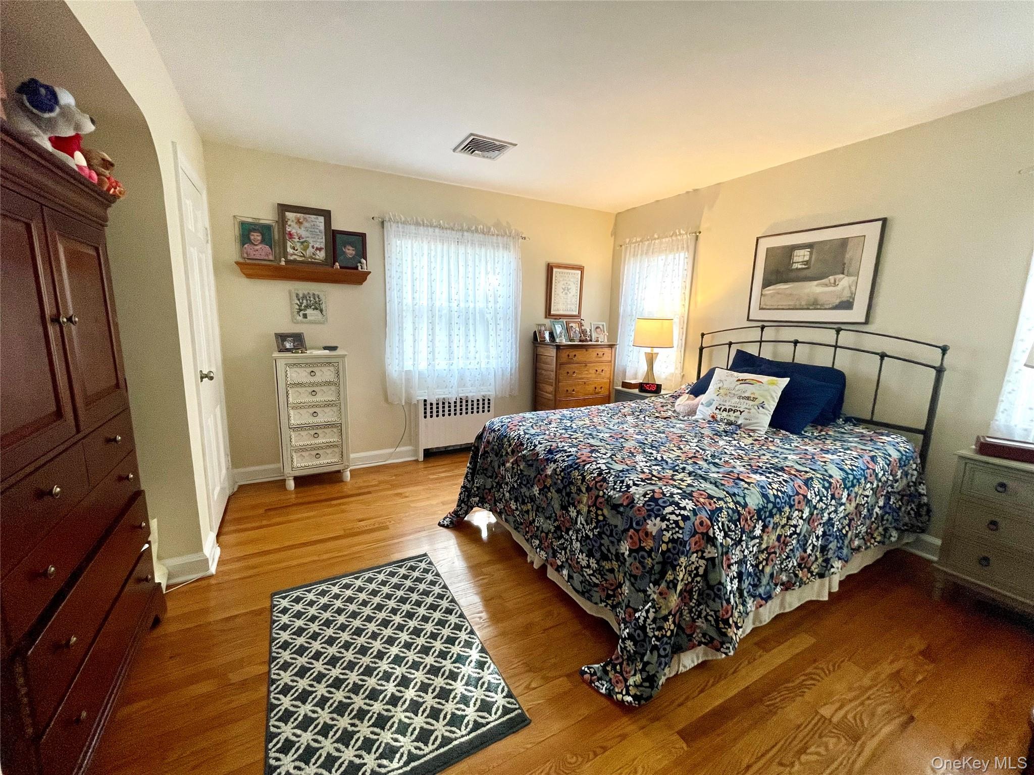 4 Sylvan Way Suffern, NY 10901 - Photo 18 of 39 a bedroom with a bed and wooden floor