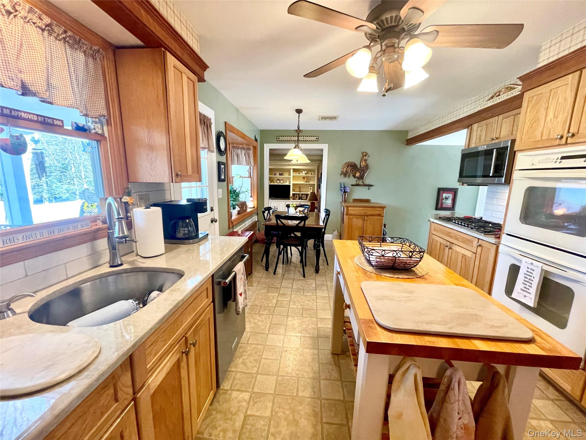 4 Sylvan Way Suffern, NY 10901 - Photo 10 of 39 a kitchen with sink refrigerator and window