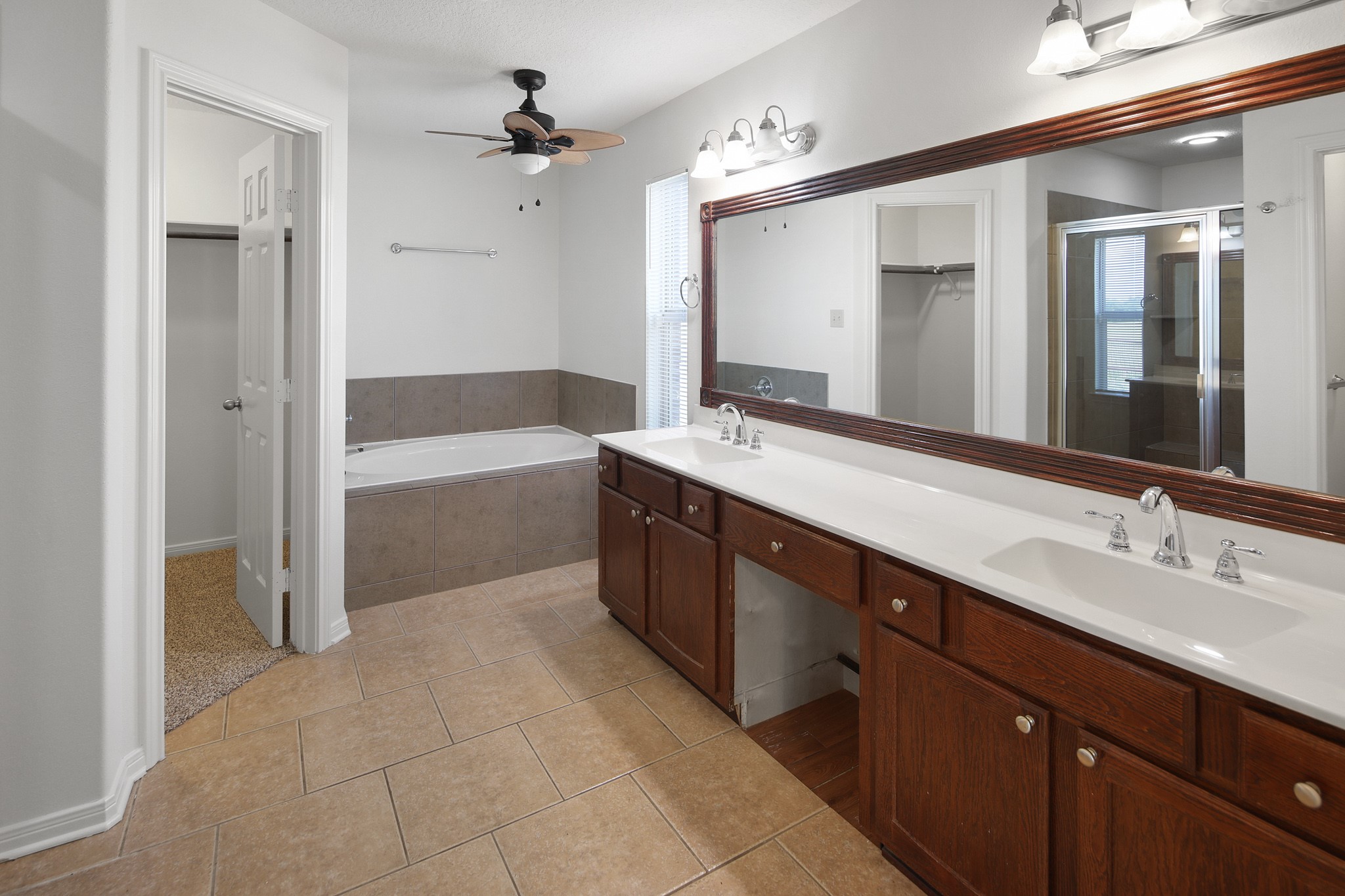 7808 Oxford Cemetery Road Madisonville, TX 77864 - Photo 11 of 16 a spacious bathroom with a tub sink shower and mirror