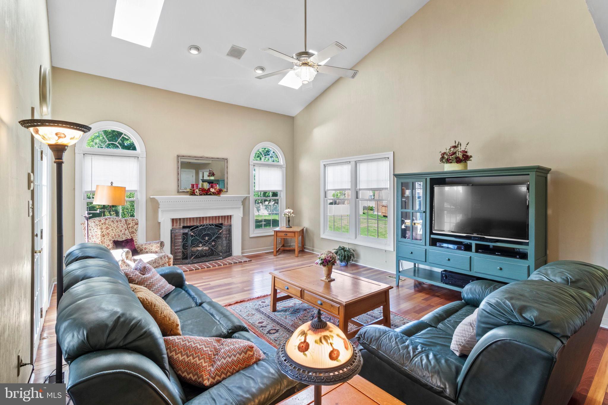 15 Byron Drive Mount Laurel, NJ 08054 - Photo 16 of 60 a living room with furniture a fireplace and a flat screen tv