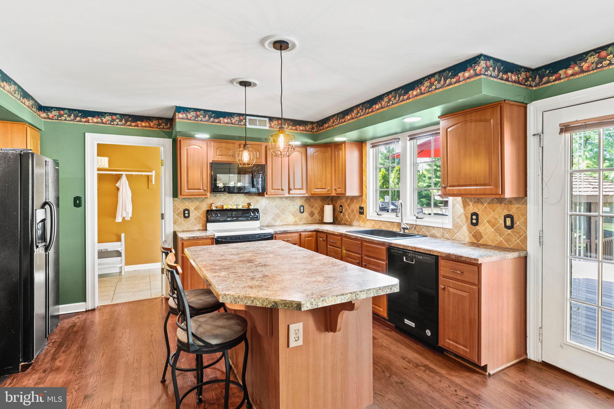 15 Byron Drive Mount Laurel, NJ 08054 - Photo 18 of 60 a kitchen with stainless steel appliances granite countertop wooden floor granite top table and chairs