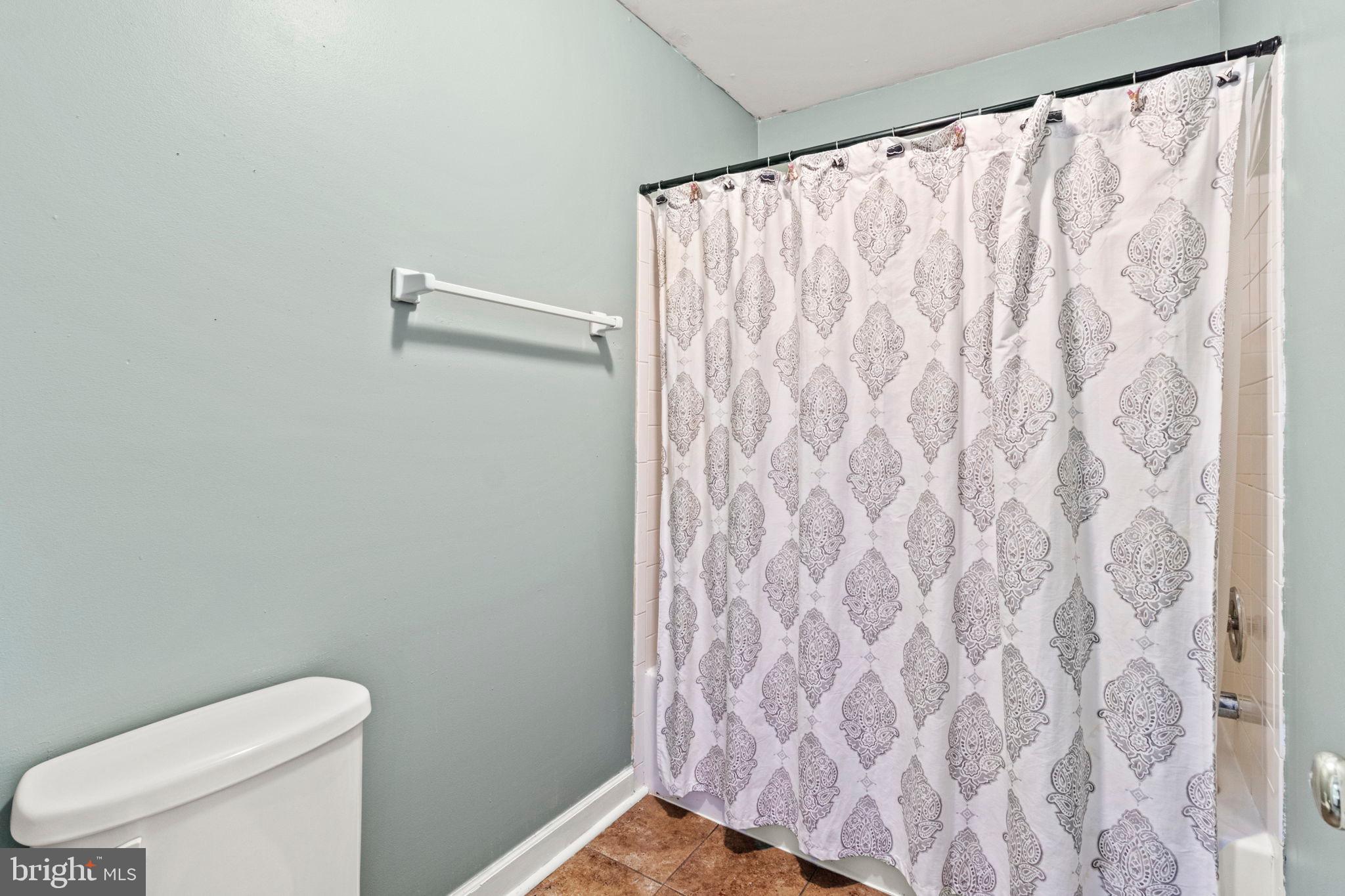15 Byron Drive Mount Laurel, NJ 08054 - Photo 35 of 60 a white toilet sitting next to a shower curtain