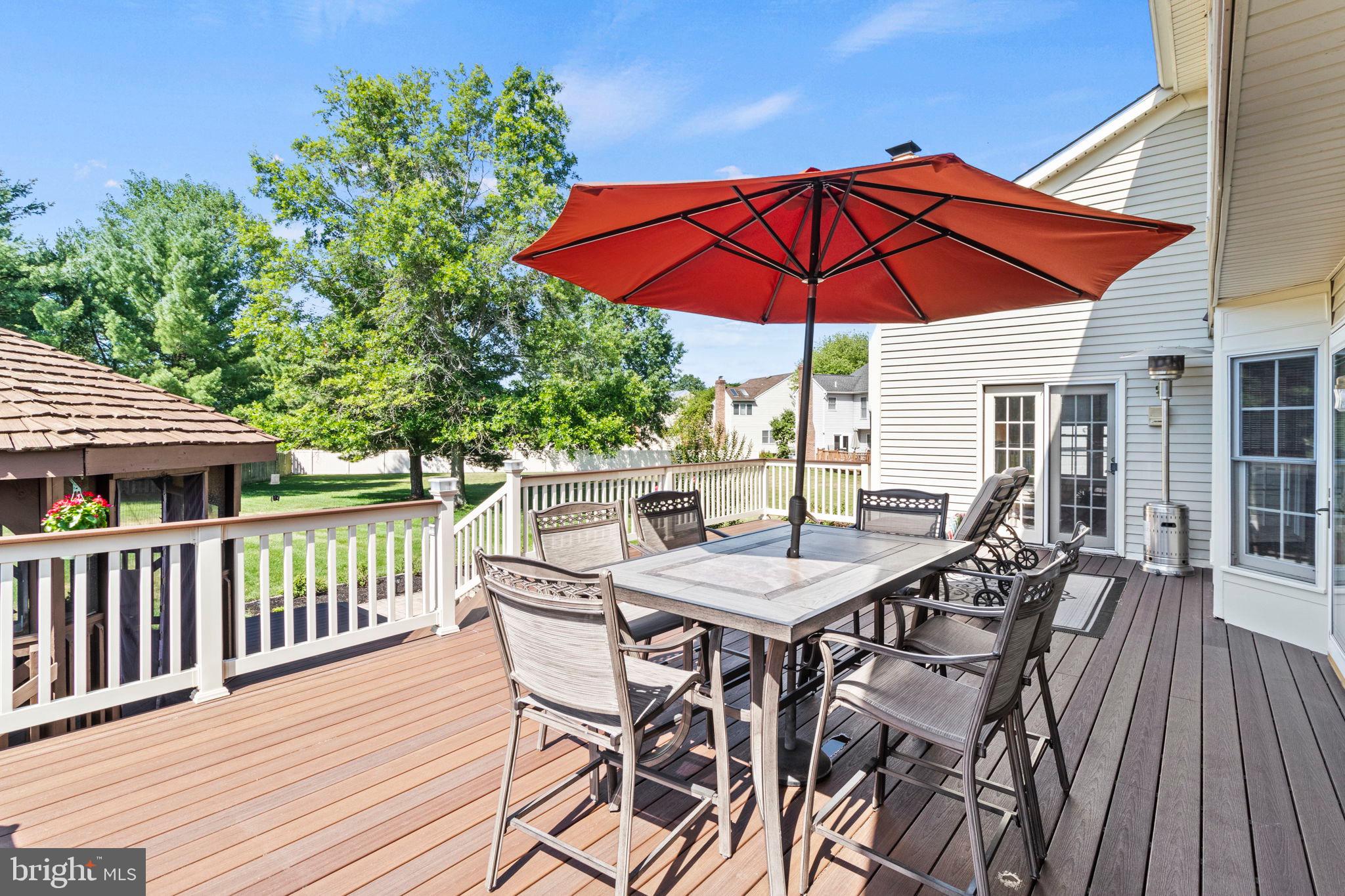 15 Byron Drive Mount Laurel, NJ 08054 - Photo 49 of 60 a patio with wooden floor a yard a table and chairs