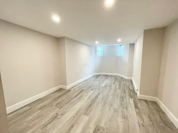 a view of empty room with wooden floor