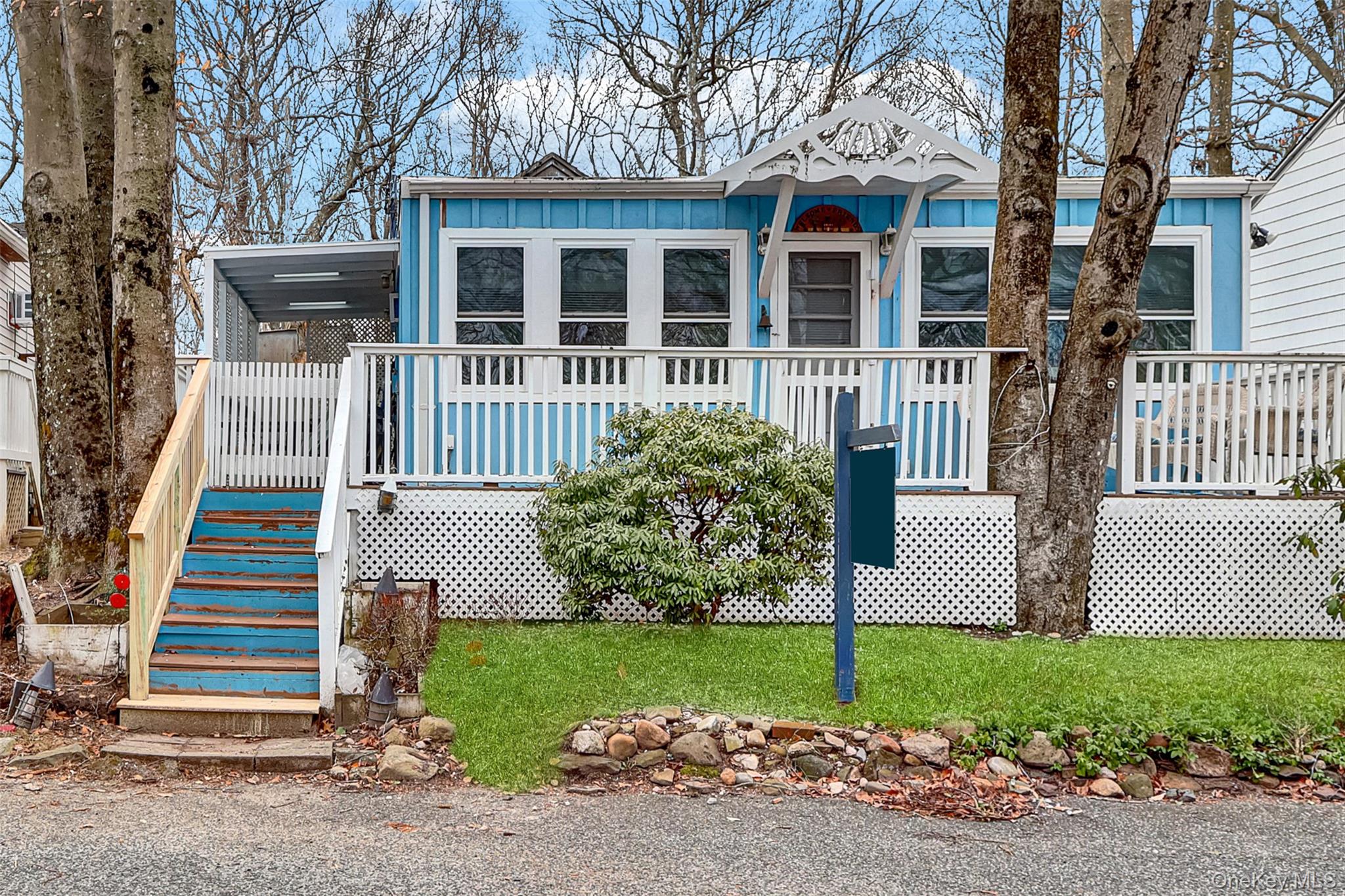 21 Cottage Road Baiting Hollow, NY 11933 - Photo 3 of 28 a front view of a house with a yard and large tree