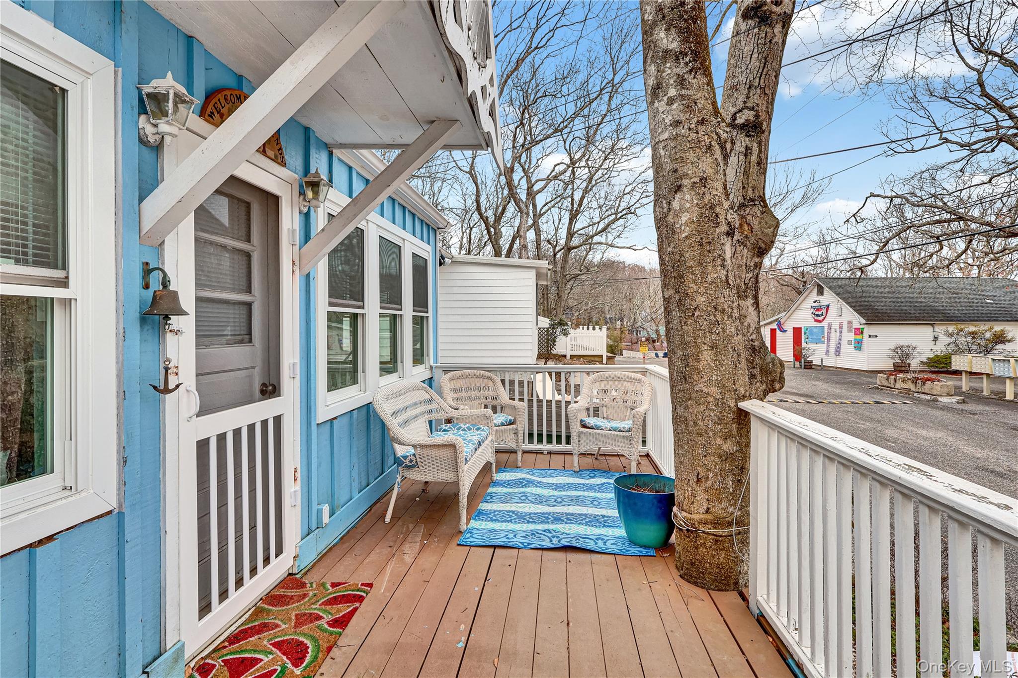 21 Cottage Road Baiting Hollow, NY 11933 - Photo 4 of 28 a balcony with wooden floor and furniture