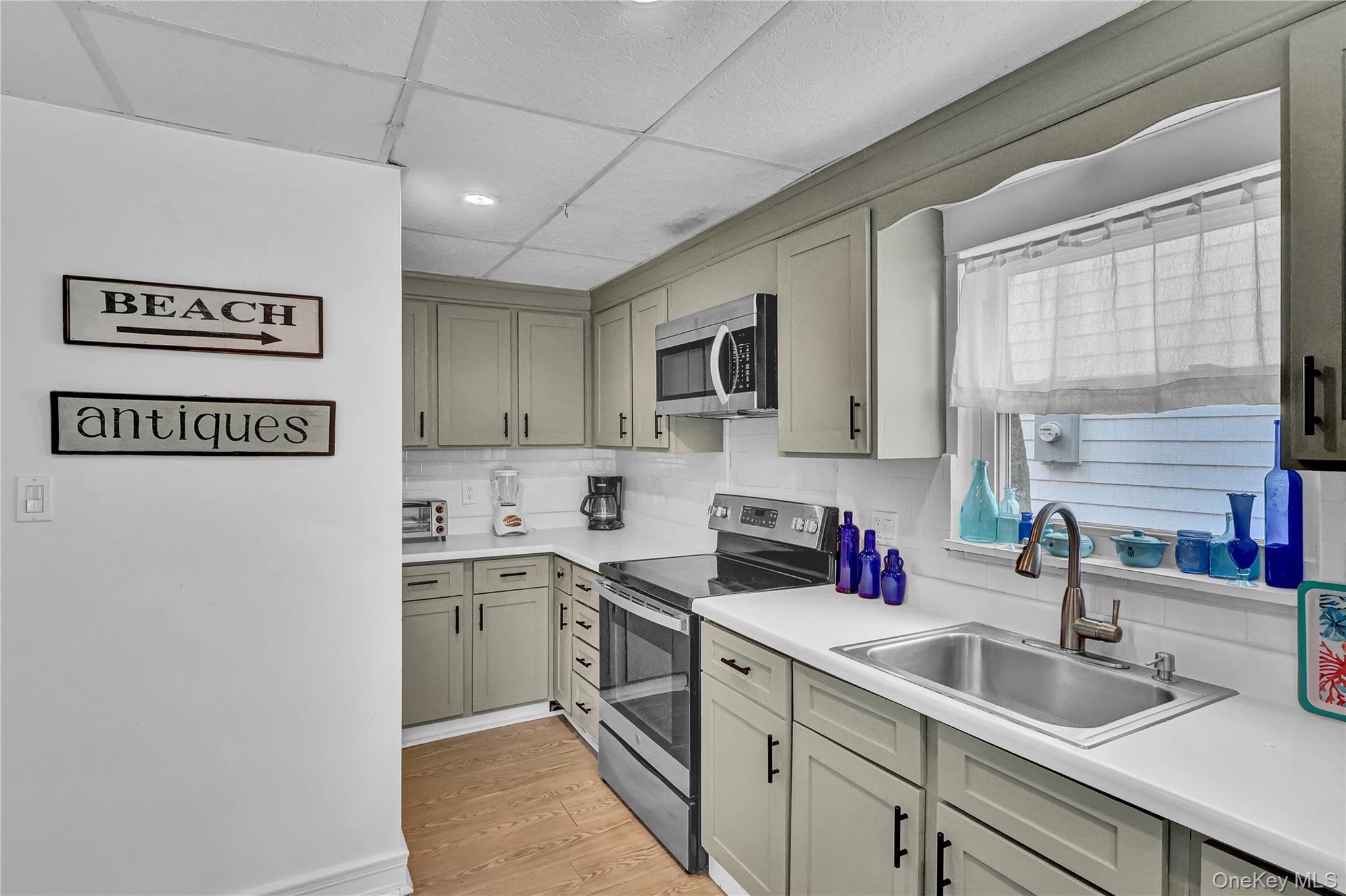 21 Cottage Road Baiting Hollow, NY 11933 - Photo 6 of 28 a kitchen with a sink cabinets and window