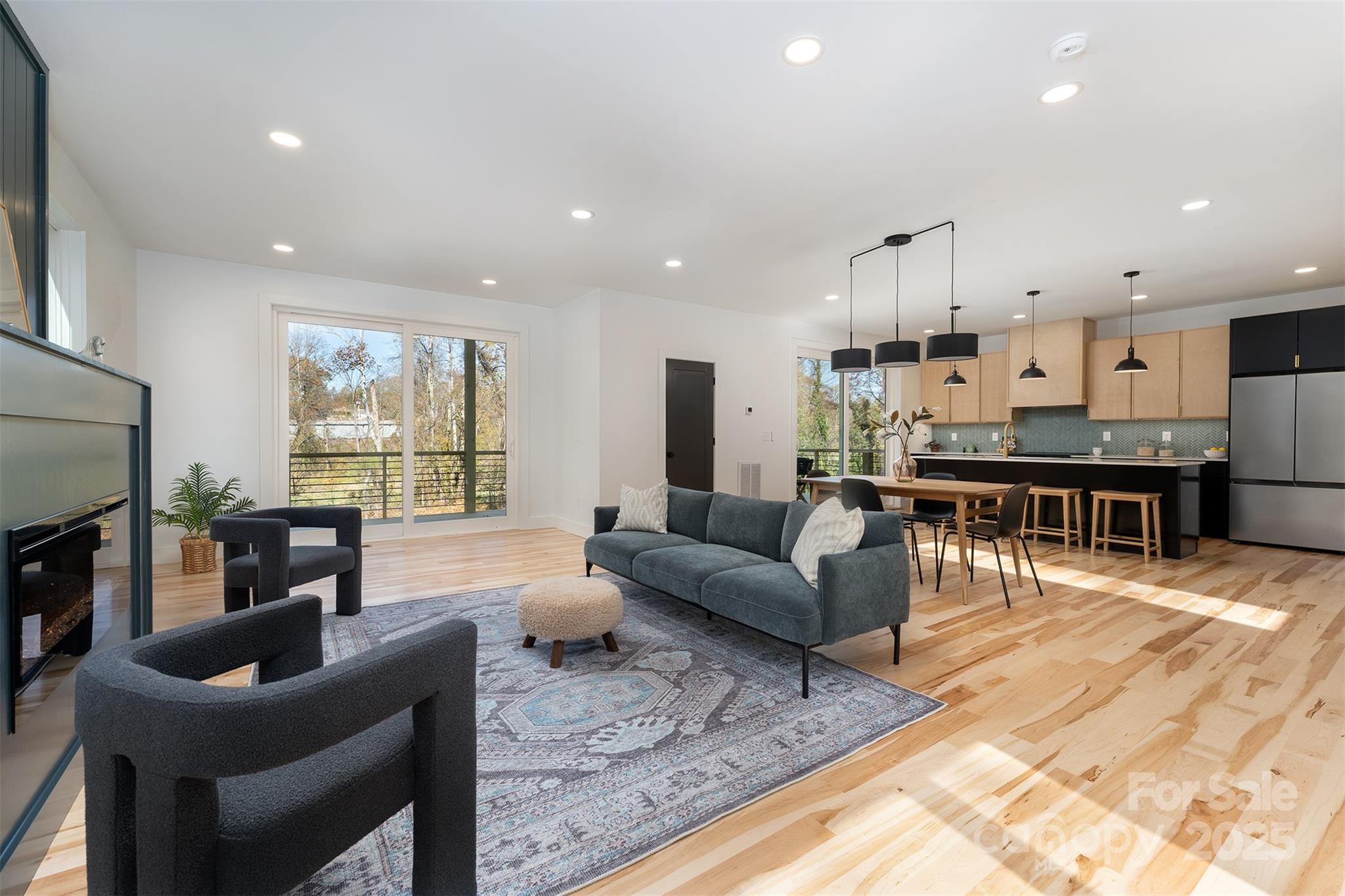 110 Providence Road Asheville, NC 28806 - Photo 14 of 36 a living room with furniture a wooden floor and a large window