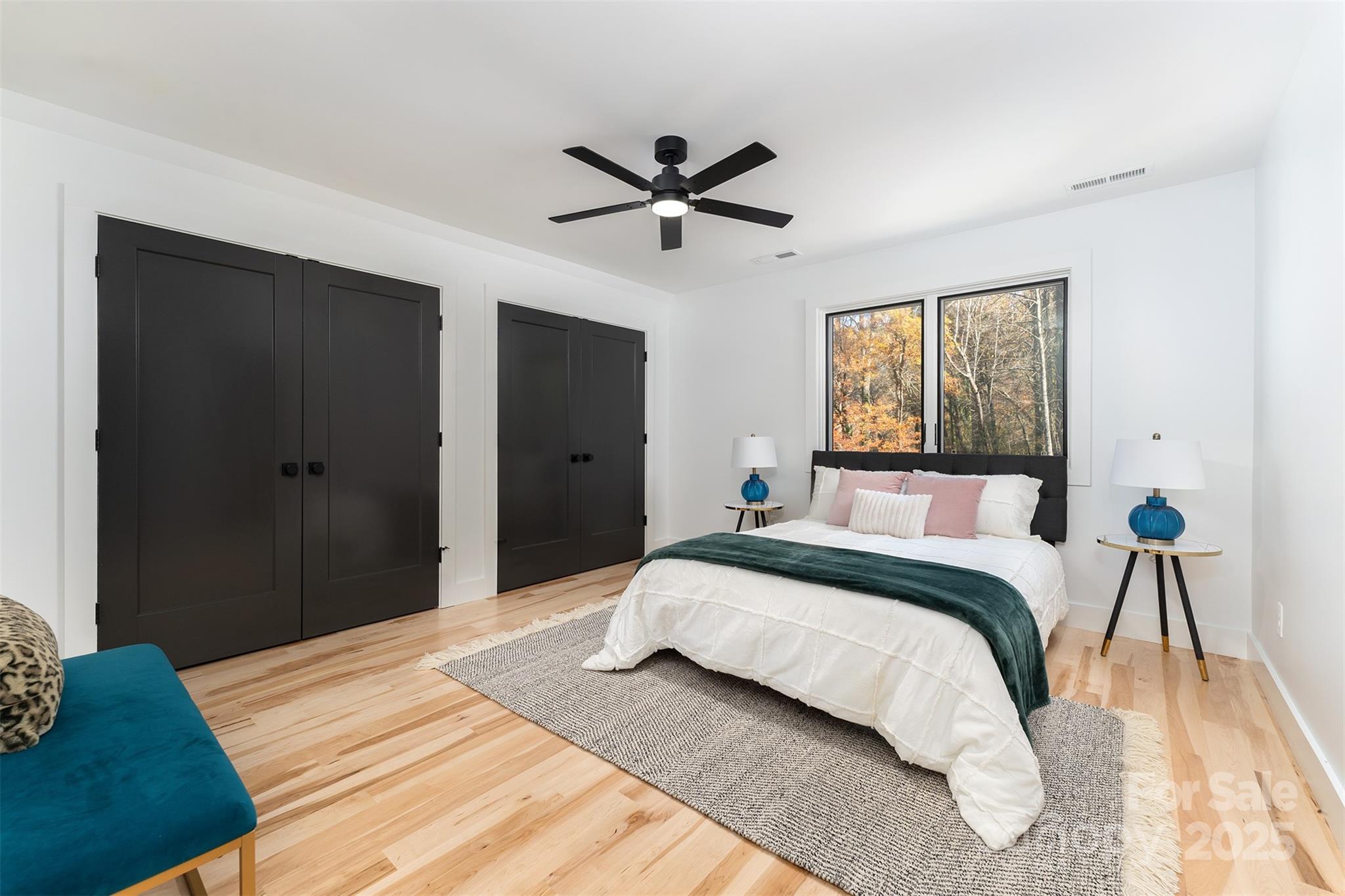 110 Providence Road Asheville, NC 28806 - Photo 18 of 36 a bedroom with a large bed and a chandelier