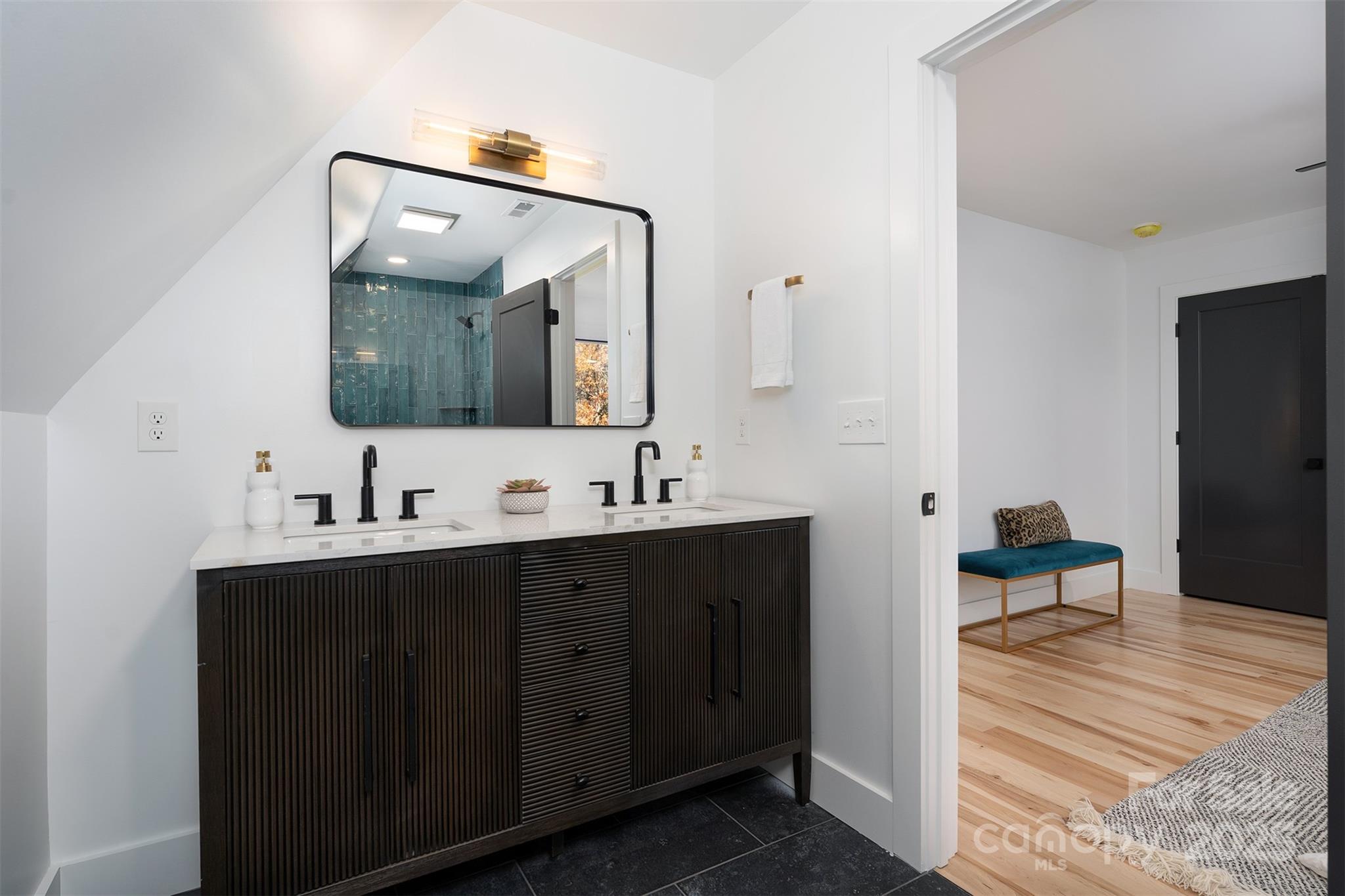 110 Providence Road Asheville, NC 28806 - Photo 20 of 36 a en suite bathroom with a double vanity sink and a mirror