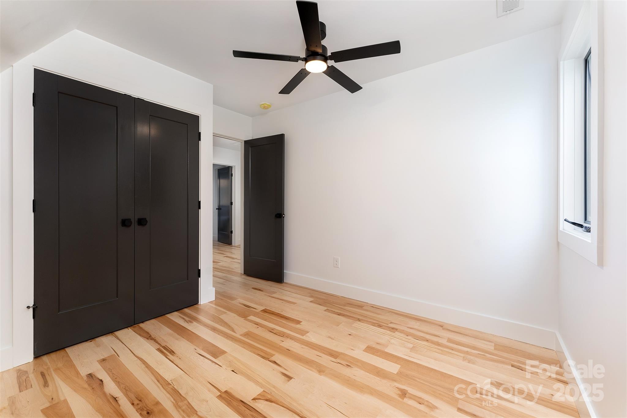 110 Providence Road Asheville, NC 28806 - Photo 21 of 36 a bedroom with a bed and a chandelier