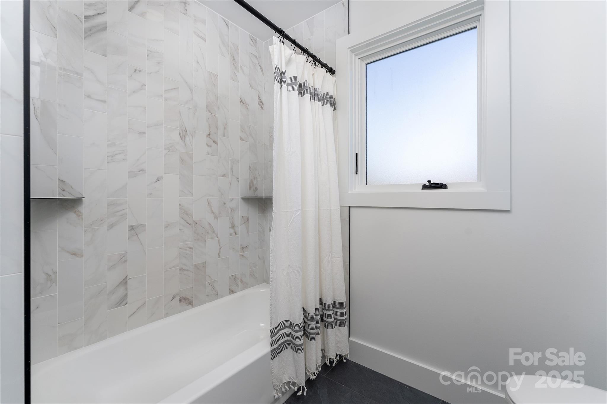 110 Providence Road Asheville, NC 28806 - Photo 23 of 36 a bathroom with a bathtub and a shower