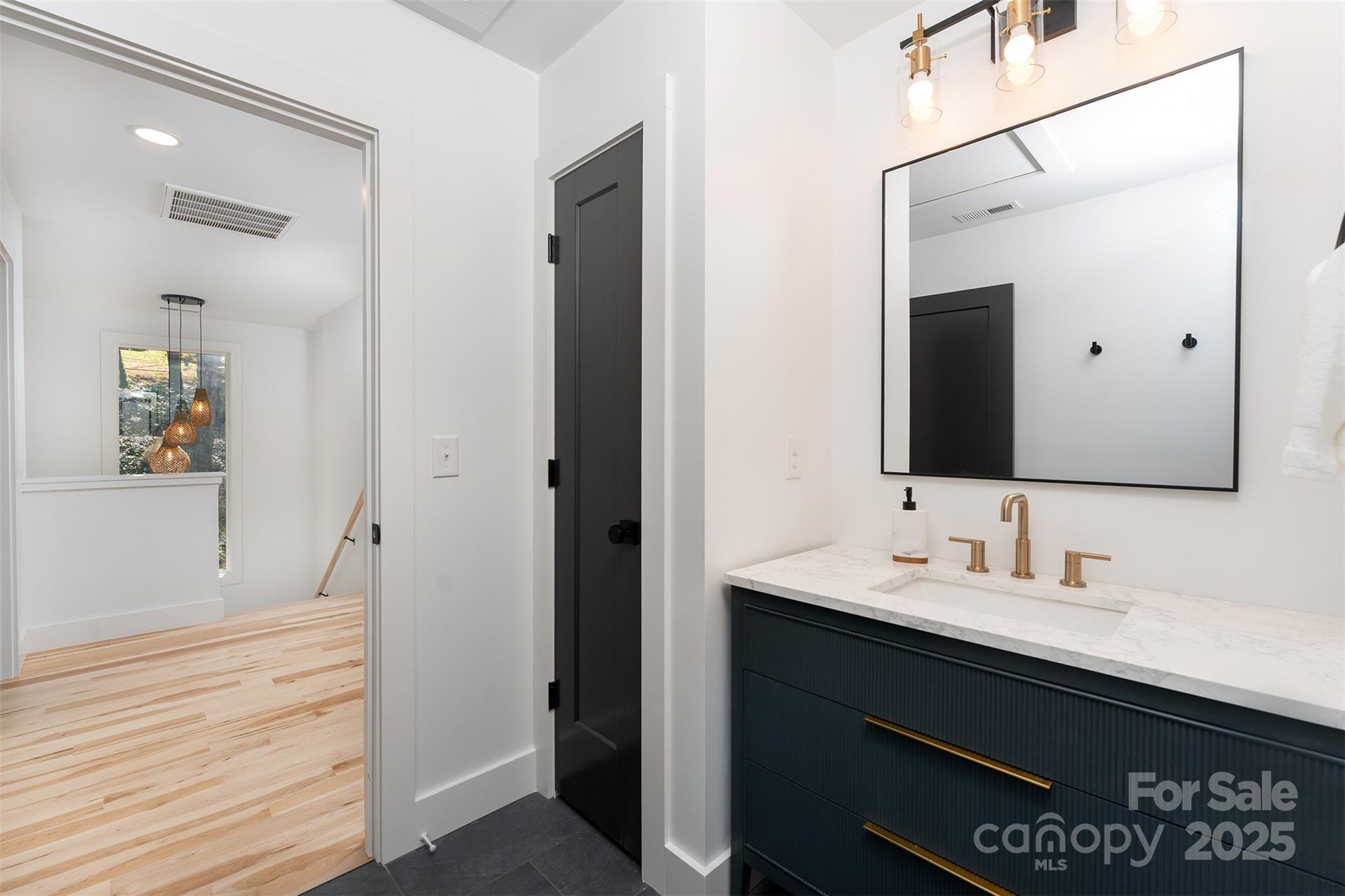 110 Providence Road Asheville, NC 28806 - Photo 24 of 36 a bathroom with a sink and a mirror