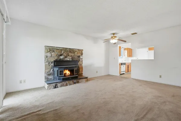 a view of an empty room with a fireplace
