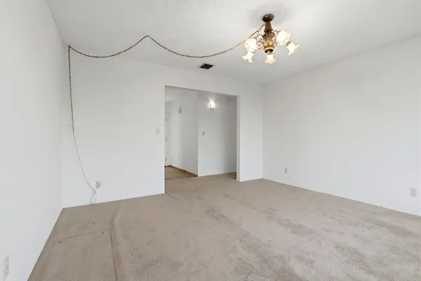 a view of a chandelier fan and a chandelier fan in a room
