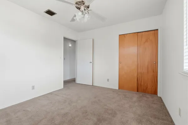an empty room with a view of a hallway