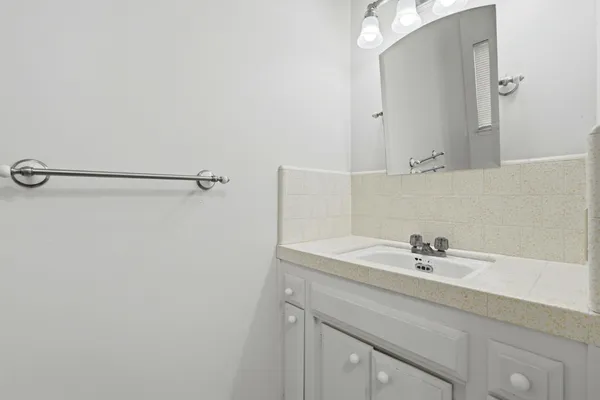 a bathroom with a sink and a white cabinet