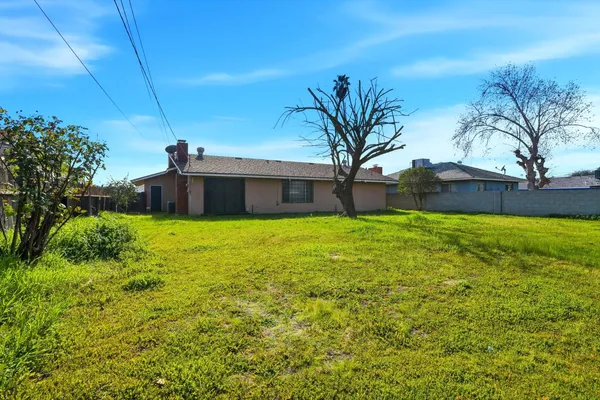 a front view of house with yard and trees