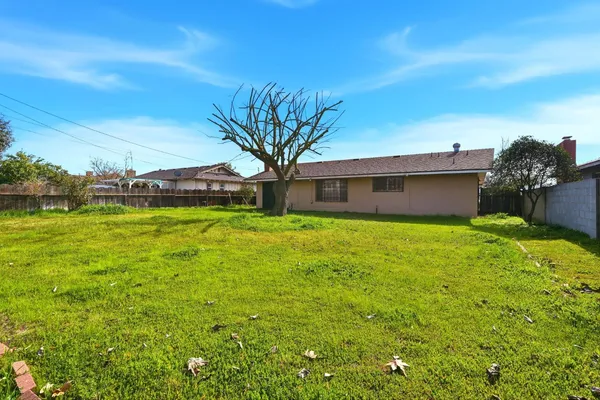 a yellow house with garden in front of it