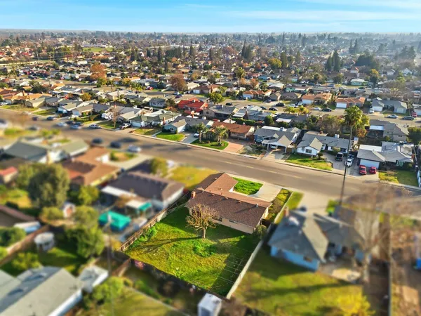 an aerial view of residential houses with outdoor space and swimming pool