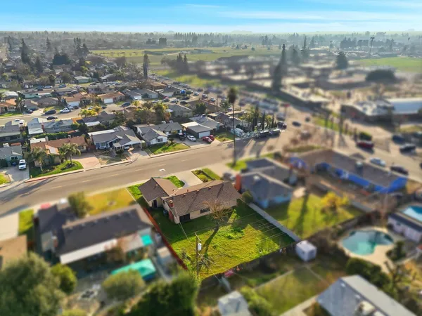 an aerial view of residential houses with outdoor space