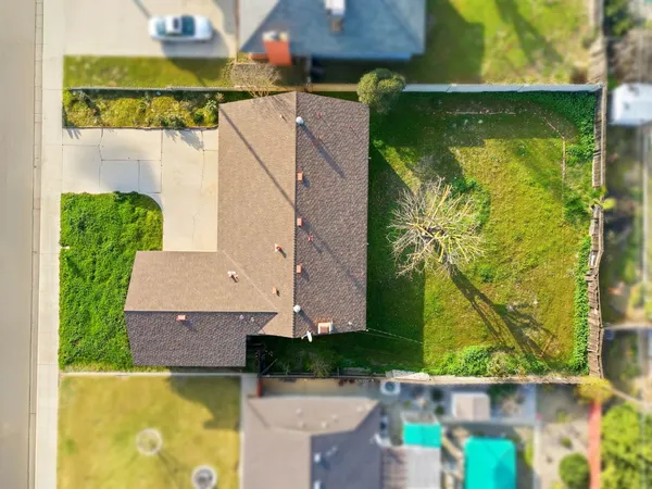 an aerial view of a house with a garden and swimming pool