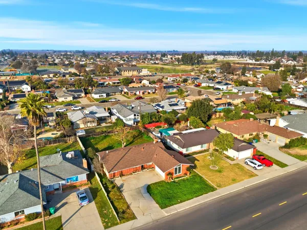an aerial view of residential houses with city view