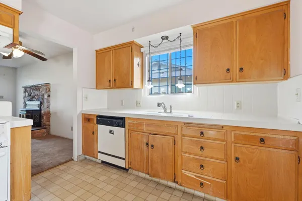 a kitchen with cabinets appliances and a sink