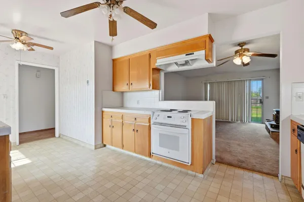 a view of a kitchen sink and dishwasher with wooden floor