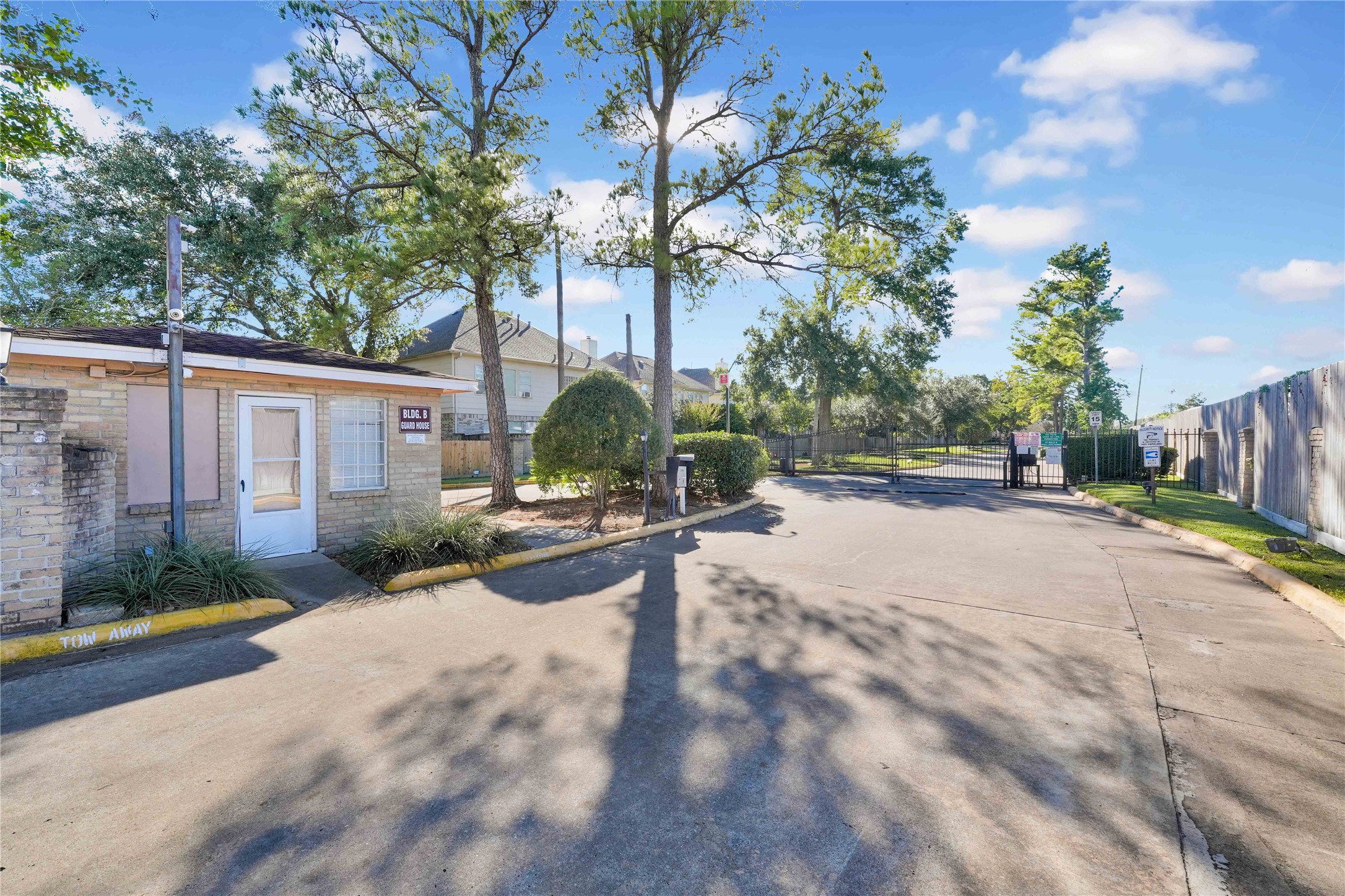 2800 Jeanetta Street, Unit 910 Houston, TX 77063 - Photo 6 of 6 a view of a street with a bench and trees