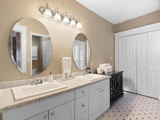 a bathroom with a sink a mirror and a shower