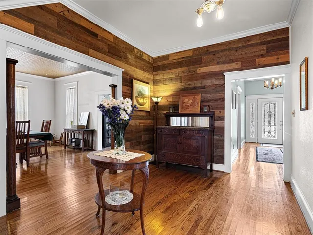 a living room with furniture a wooden floor and a chandelier