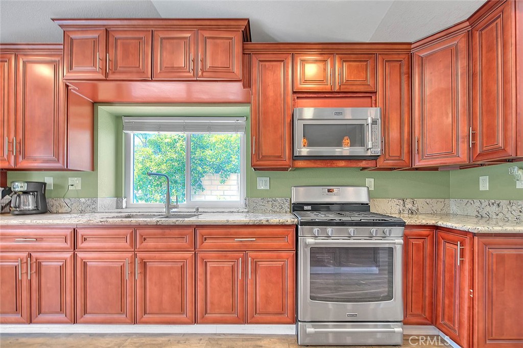 3340 May Court Riverside, CA 92503 - Photo 18 of 67 a kitchen with stainless steel appliances granite countertop a stove a sink and a microwave