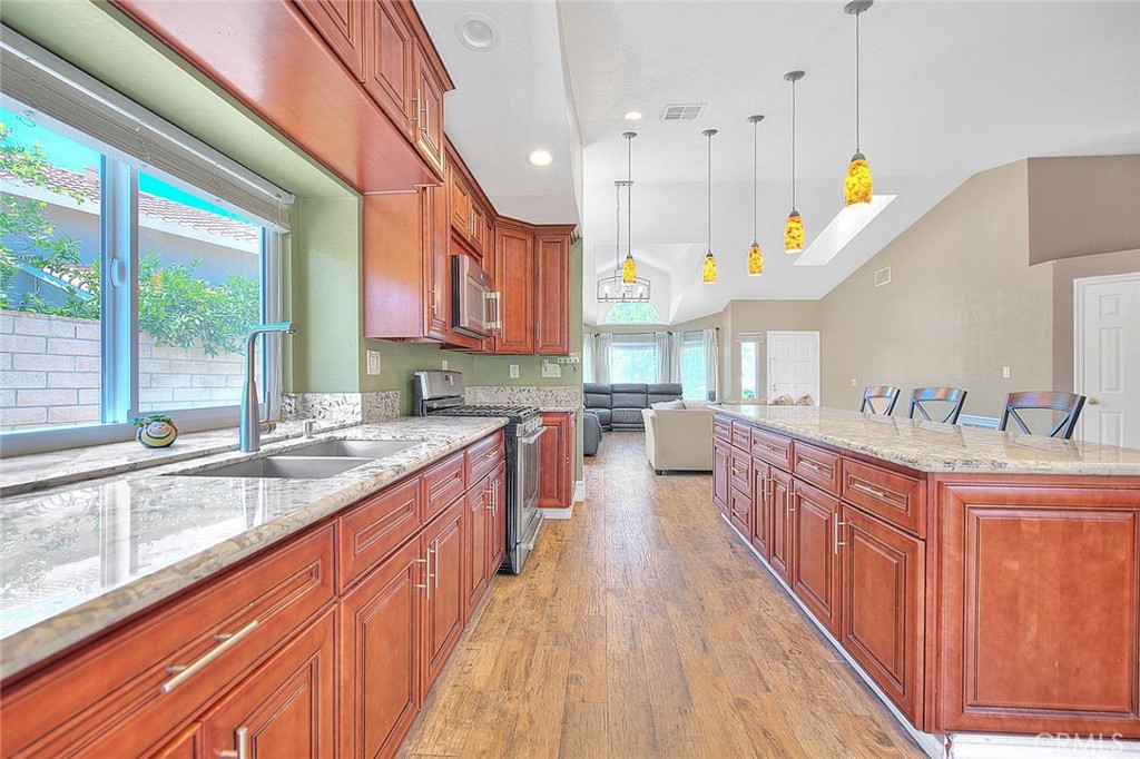 3340 May Court Riverside, CA 92503 - Photo 21 of 67 a kitchen with kitchen island granite countertop a sink a counter top space and stainless steel appliances