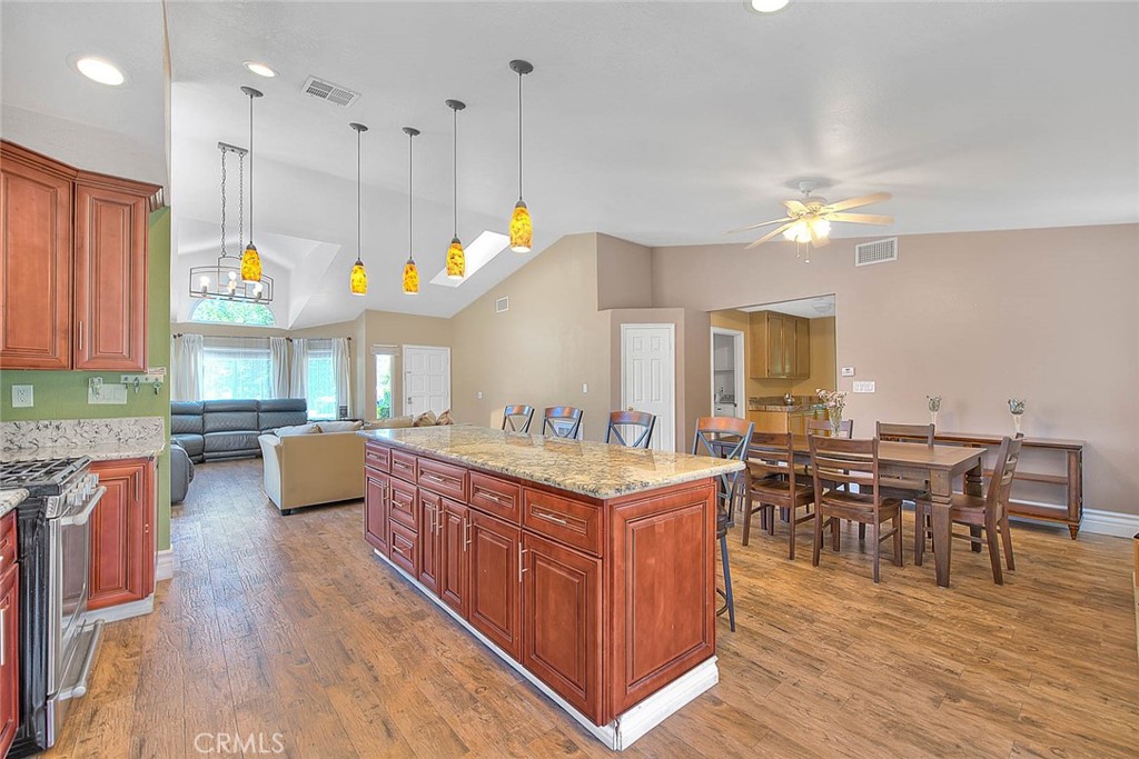 3340 May Court Riverside, CA 92503 - Photo 23 of 67 a kitchen with stainless steel appliances kitchen island wooden cabinets and dining table