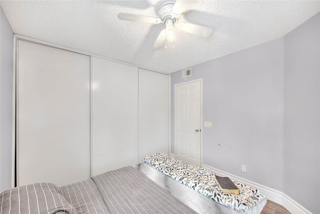 3340 May Court Riverside, CA 92503 - Photo 35 of 67 a view of a bedroom with a bed and a chandelier fan