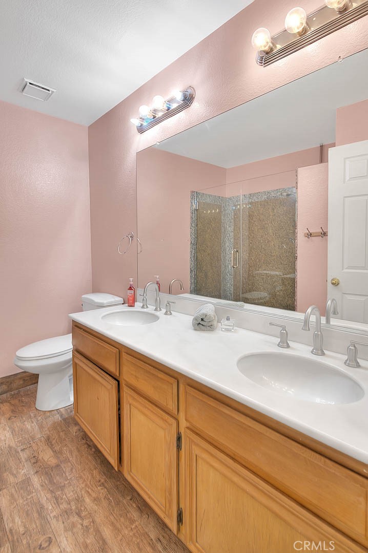 3340 May Court Riverside, CA 92503 - Photo 37 of 67 a bathroom with a granite countertop sink a toilet and a large mirror
