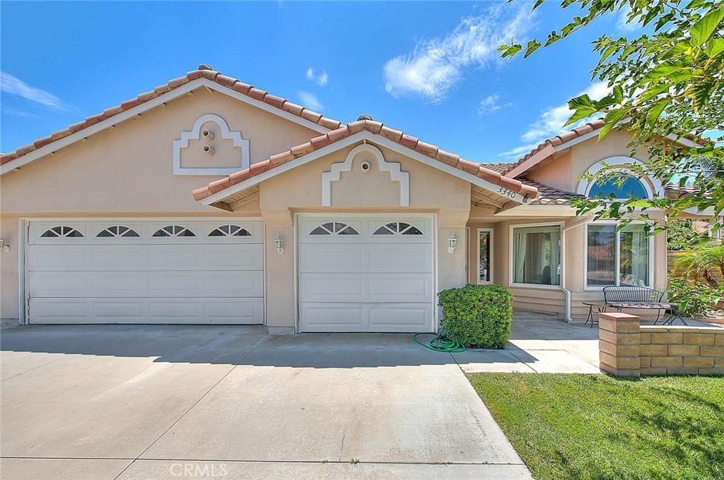 3340 May Court Riverside, CA 92503 - Photo 4 of 67 a front view of a house with a yard and garage