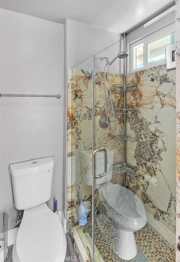 3340 May Court Riverside, CA 92503 - Photo 45 of 67 a white toilet sitting next to a shower and a sink