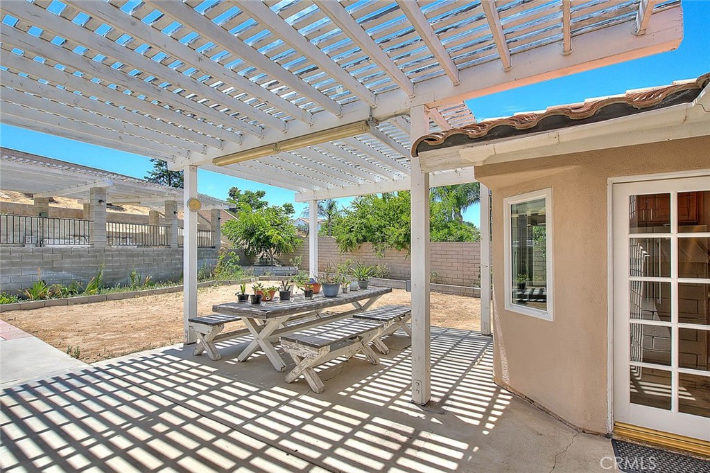 3340 May Court Riverside, CA 92503 - Photo 52 of 67 a view of a patio with a dining table and chairs